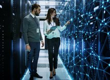 Female and Male IT Engineers Discussing Technical Details in a Working Data Center_ Server Room with Internet Connection Visualisation.jpg